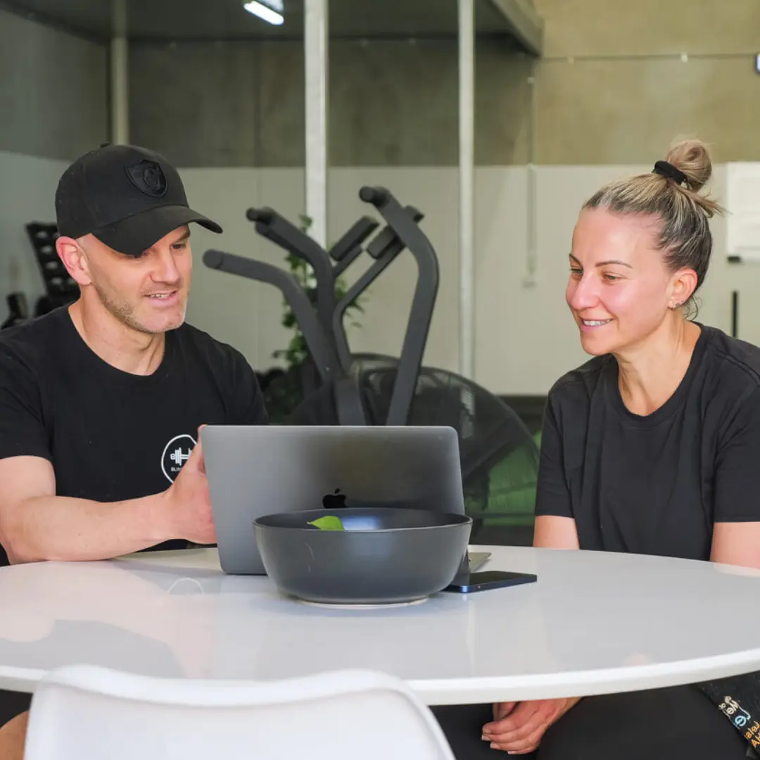 A personal trainer instructing a client on their nutrition plan